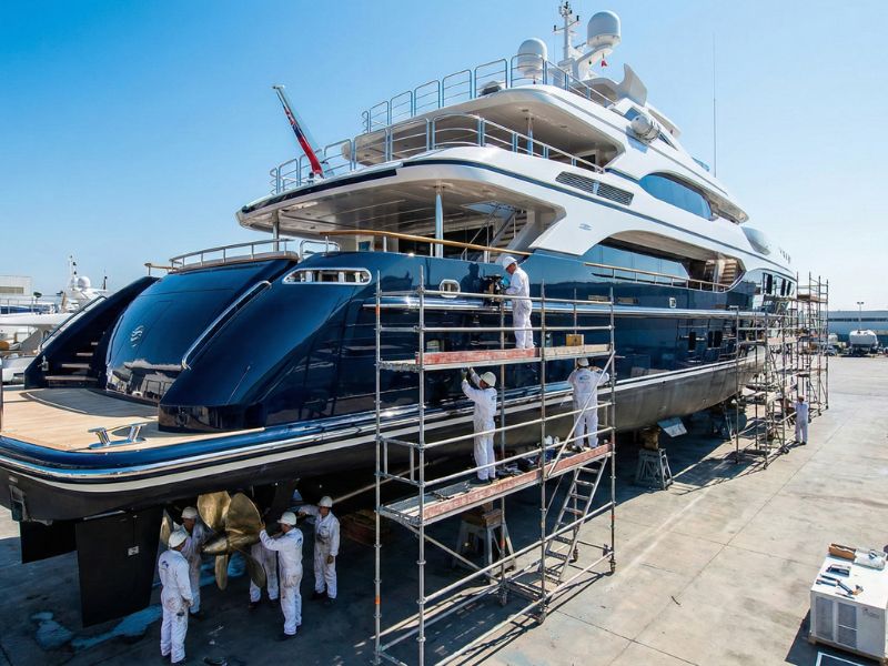 Luxury superyacht in drydock undergoing professional hull maintenance and refit by expert team