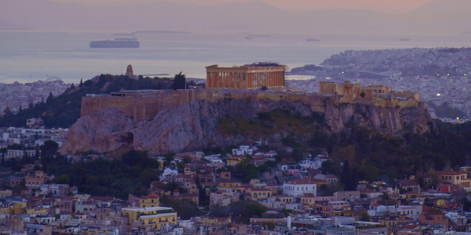 Acropolis and Parthenon at dusk overlooking Athens and the Aegean Sea